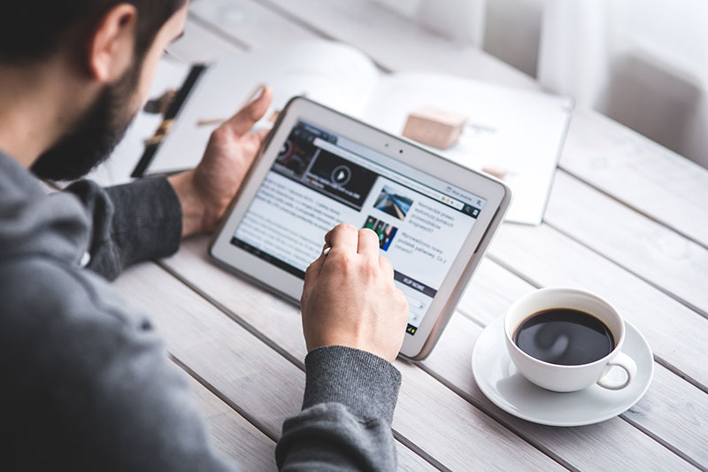 Man Browsing on Tablet